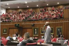  ??  ?? Arizona Democratic Rep. Reginald Bolding is applauded by striking Arizona teachers who packed the Arizona House gallery in Phoenix as he talks about the need for better school funding on Wednesday. Teachers are in the fifth day of a statewide strike....