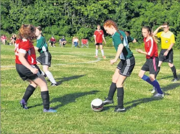  ??  ?? Kaylee Newcombe pushes past the Middleton team as she carries the ball up the field.