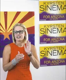  ?? Ross D. Franklin/Associated Press ?? Rep. Kyrsten Sinema, D-Ariz., talks to campaign volunteers on Aug. 28 at a Democratic campaign office in Phoenix.