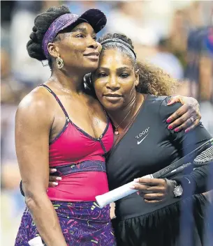  ?? JULIAN FINNEY GETTY IMAGES ?? Venus and Serena Williams hug it out after Friday night’s featured match at Flushing Meadows. Serena served up 10 aces to one by her sister, who opened the tourney with two tough matches.