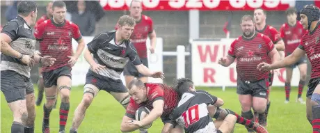  ?? Ian Moss ?? Widnes’s Mike Garrity is dragged down during last Saturday’s clash against Broughton Park at Heath Road.