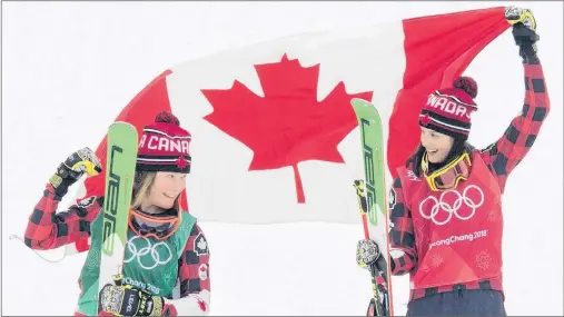  ?? THE CANADIAN PRESS/JONATHAN HAYWARD ?? Gold medalist Kelsey Serwa, right, and silver medalist Brittany Phelan celebrate their wins following the women’s ski cross at Phoenix Snow Park during the Pyeongchan­g 2018 Winter Olympic Games in South Korea, Friday.