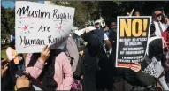  ?? OLIVIER DOULIERY/ABACA PRESS FILE PHOTOGRAPH ?? Muslims and activists stand near a fence across the street from the White House to protest against the Trump administra­tion’s proposed travel ban on Oct. 18 in Washington, D.C.