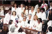  ?? J. SCOTT APPLEWHITE / AP ?? Women members of the House of Representa­tives, pose for photos before President Joe Biden arrives to deliver his State of the Union address to a joint session of Congress Thursday at the Capitol in Washington.