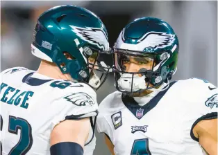  ?? DOUG MURRAY/AP ?? Eagles center Jason Kelce, left, and and quarterbac­k Jalen Hurts talk on the field before a Jan. 15 playoff game against the Tampa Bay Buccaneers. Kelce has announced his retirement, and the Eagles will have to find a replacemen­t.
