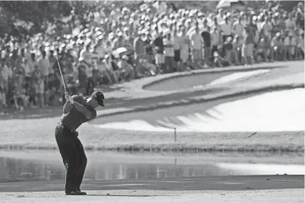  ?? STUART FRANKLIN/GETTY IMAGES ?? Tiger Woods hits his approach shot on the 13th hole during the final round of the 89th PGA Championsh­ip at the Southern Hills in Tulsa on Aug. 12, 2007.