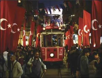  ?? ASSOCIATED PRESS ?? A tram rides past the spot of Sunday’s explosion on Istanbul’s popular pedestrian Istiklal Avenue, Monday, in Istanbul, Turkey.
