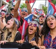  ?? ILANA PANICH-LINSMAN / THE NEW YORK TIMES ?? People celebrate the resignatio­n of Gov. Ricardo Rossello during a march in San Juan, Puerto Rico, on Thursday. Many protesters said it felt like a vindicatio­n for victims of Hurricane Maria.