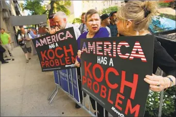  ?? Spencer Platt Getty Images ?? PROTESTERS rally in 2014 outside the New York apartment of David Koch, who died Friday. Koch and his brother Charles set up a network of donors who spent an estimated $900 million during the 2016 elections.