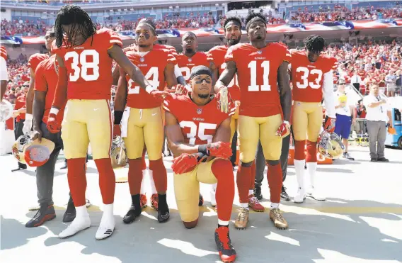  ?? Marcio Jose Sanchez / Associated Press ?? San Francisco 49ers safety Eric Reid kneels during the national anthem before a game last month. The protest was started by former 49er Colin Kaepernick.