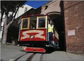  ?? ERIC RISBERG — THE ASSOCIATED PRESS ?? Superinten­dent Arne Hansen rides a cable car dedicated to Tony Bennett out of a barn as it begins a run in San Francisco on March 14. Tony Bennett loved San Francisco and its cable cars, and in return the city has dedicated one of those cable cars to the late famous crooner.