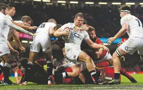  ?? AFP ?? England’s hooker Dylan Hartley (centre) pulls the ball out of a ruck during the Six Nations match against Wales. England’s workload during training helped them withstand Wales’ onslaught on Saturday, the captain and coach Eddie Jones believe.