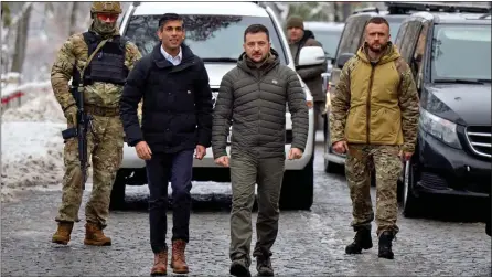  ?? ?? SHOULDER TO SHOULDER: Rishi Sunak with Volodymyr Zelensky and bodyguards walk the streets of under-fire Kyiv yesterday