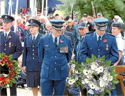  ??  ?? Police have traditiona­lly laid wreaths at Anzac Day services, but they’re cutting back on the practice.