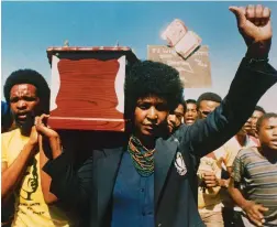  ?? PICTURE: AP PHOTO ?? COMRADES: Winnie Mandela, carries the coffin of activist William Kotoyi at his funeral in Brandfort.