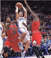  ?? CHRIS SZAGOLA/AP ?? 76ers' T.J. McConnell tries to put up the shot as he splits between Bulls' Jimmy Butler and Jerian Grant.