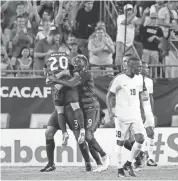  ?? KIM KLEMENT/USA TODAY SPORTS ?? U.S. defender Omar González (3) is congratula­ted by midfielder Paul Arriola (20) and midfielder Gyasi Zardes (9) after he scored a goal against the Martinique on Wednesday.