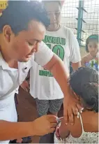  ?? Photo: Ronald Kumar ?? Samabula Health Centre Staff Nurse, Emmanuel Pene assists 10 year-old Pisila Gino of Tuvalu with free measles vaccinatio­n on November 13, 2019.