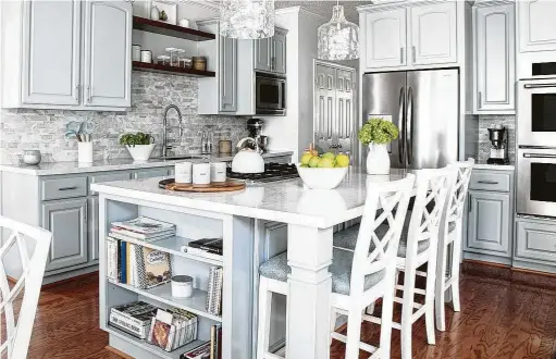  ?? Photos by Richard Davis Photograph­y ?? Erin and Aaron Sorrell’s kitchen in their Katy home got an update with a new island, painted cabinets and new tile and counters.