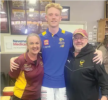  ?? ?? Ryan Maric (centre) dons his West Coast colours in the Drouin Football Club social rooms with club secretary Rebecca Virtue (left) and president Chris Soumilas (right).