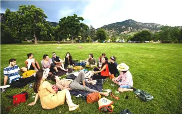  ??  ?? Friends gather for an evening dinner at Chautauqua Park in Boulder, Colorado. The park was founded in 1898, featuring eight hiking trails, a playground, dining hall, and general store.