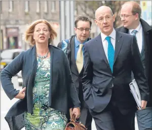  ?? Picture: PA. ?? SNP representa­tives Finance Secretary John Swinney and MSP Linda Fabiani arrive for the all-party talks at the Smith Commission in Edinburgh.
