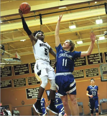  ?? Photos by Ernest A. Brown ?? Woonsocket senior Dwayne Robinson-O’Hagan (5), seen here gliding past Cumberland’s William Andrews (11), scored a game-high 31 points in the Novans’ 64-59 victory over the Clippers Wednesday night. Mount junior wing Jordan Perry (22, below) scored 12 points in his team’s 65-33 victory over Paul Cuffee.