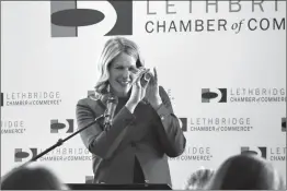  ?? HERALD PHOTO BY ALEJANDRA PULIDO-GUZMAN ?? Lethbridge MP Rachael Thomas looks through her kaleidosco­pe while using it as an analogy to share her story at a recent Lethbridge Chamber of Commerce event at the Enmax Centre.