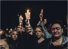  ?? STEPHANIE KEITH GETTY IMAGES ?? Mourners in Amsterdam, N.Y., attend a candleligh­t vigil Monday for the victims of the limousine crash that killed 20 people on Saturday.