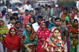  ?? A.M. AHAD — THE ASSOCIATED PRESS FILE ?? Garment workers arrive for work early morning in Dhaka, Bangladesh.