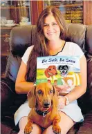  ??  ?? Harriet Bremner with her children’s book, Be Safe, Be Seen, and her daschund.