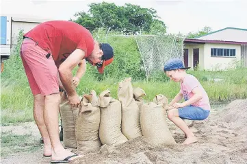  ??  ?? Residents fill sandbags in preparatio­n for the arrival of Cyclone Debbie in the northern Australian town of Bowen, located south of Townsville. — Reuters photo