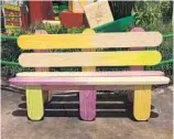  ?? GABRIELLE RUSSON/STAFF ?? A bench that looks as if it’s made of used wooden Popsicle sticks, stained faintly by the different flavors, offers a place to sit in Toy Story Land. A merchandis­e cart that looks like a camper sells souvenir Woody, Jesse, Buzz Lightyear and Rex toys.