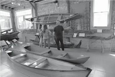  ?? Dave G. Houser/TNS ?? ■ Visitors peruse exhibits at the Center for Traditiona­l Louisiana Boat Building in Lockport, La.