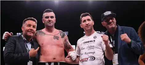  ??  ?? Niall Kennedy celebrates with, from left, Ken Casey of Murphy’s Boxing promotions, trainer Packie Collins and Sean Sullivan of Murphy’s Boxing promotions after winning his heavyweigh­t bout against Brendan Barrett at TD Garden in Boston.