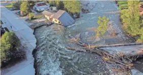  ?? DAVID GOLDMAN/AP ?? A house sits in Rock Creek Wednesday after floodwater­s washed away a road and a bridge in Red Lodge, Mont. No one was reported hurt.