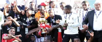  ??  ?? Bosso players and officials celebrate after winning the Chibuku Super Cup against Ngezi Platinum FC in a match played at Barbourfie­lds Stadium. yesterday