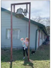  ?? PHOTOS BY ANDREA BRUNER/CONTRIBUTI­NG PHOTOGRAPH­ER ?? Miranda Childers’ daughter Addie, 11, helps the youngest, 2-year-old Millie Jo, ring the bell at the New Hope Refuge campus, once home to a Baptist camp.