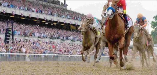  ?? BARBARA D. LIVINGSTON ?? With Mike Smith aboard, Justify wins the Belmont Stakes and becomes racing’s 13th Triple Crown winner in only his sixth start.