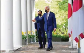  ?? THE NEW YORK TIMES ?? President Joe Biden and Japanese Prime Minister Yoshihide Suga walk to the Rose Garden at the White House on Friday for a news conference. Suga’s visit marked Biden’s first face-to-face talks with a foreign leader as president.