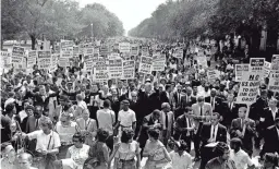  ?? AP FILE ?? Martin Luther King Jr., center, marches with other civil rights protesters during the March on Washington on Aug. 28, 1963.