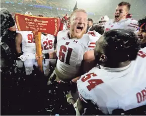  ?? SENTINEL MARK HOFFMAN / MILWAUKEE JOURNAL ?? Wisconsin center Tyler Biadasz, holding Paul Bunyan's Axe, will likely be playing his final game for the Badgers in the Rose Bowl.