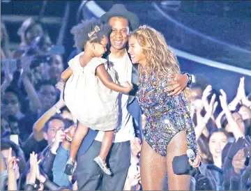  ??  ?? Jay-Z with Beyonce and daughter Blue Ivy after accepting the Video Vanguard Award on stage during the 2014 MTV Video Music Awards. — Reuters file photo