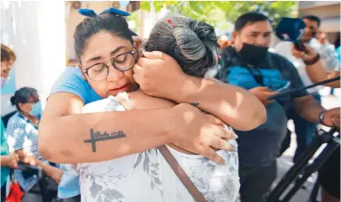  ?? Photos: AP ?? People embrace outside the court following the verdict in Gustavo Zanchetta’s trial in Oran, Argentina – home country of Pope Francis.