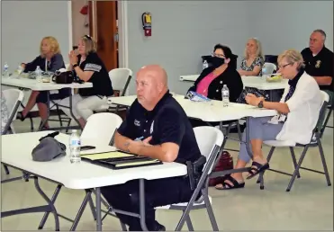  ?? Doug Walker ?? Cave Spring Police Chief Greg Webb (center) is among the law enforcemen­t officers at a meeting of the North Georgia Elder Abuse Task Force in Rome on Tuesday.