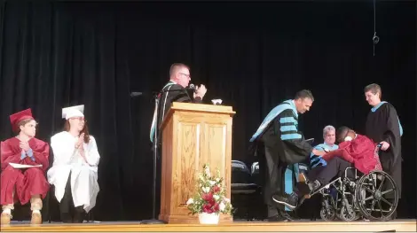  ?? EVAN BRANDT — MEDIANEWS GROUP ?? Pottsgrove Schools Superinten­dent William Shirk delivers JaSaad Jamison’s high school diploma during Thursday’s special graduation ceremony.