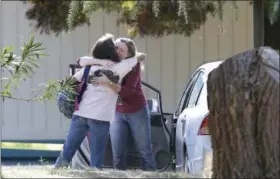  ?? RICH PEDRONCELL­I — THE ASSOCIATED PRESS ?? Two women embrace outside Rancho Tehama Elementary School, where a gunman opened fire Tuesday in Corning Authoritie­s said, a gunman choosing targets at random, opened fire in a rural Northern California town Tuesday, killing four people at several...