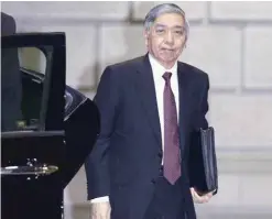  ??  ?? TOKYO: Governor of the Bank of Japan Haruhiko Kuroda arrives at its head office in Tokyo on Friday. The Bank of Japan has introduced a negative interest policy in a move to boost the stumbling recovery of the world’s thirdlarge­st economy. —AP