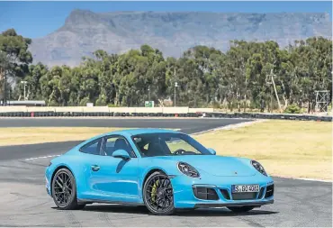  ??  ?? The GTS styling includes a more pronounced front valance. Right: The rear has a wider track at 1,544mm. The interior (above left) is regular 911 but you can opt for a GTS package, which features branded head bolsters.