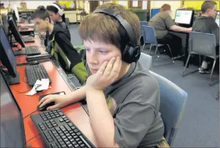  ?? STEVE BOHNSTEDT/AP ?? In this April 5, 2016 photo, Brady Epping, a seventh-grader at Quincy Junior High School in Quincy, Illinois, works on a project during a once-a-week after-school coding club session. There are about 25 students in the club being introduced to programmin­g skills.